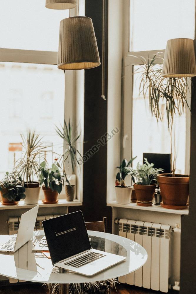 turned-off-macbook-pro-on-round-glass-top-table-1627925