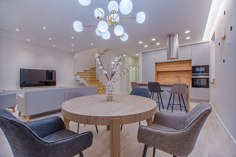 round-brown-wooden-table-with-chairs-inside-room-1668860